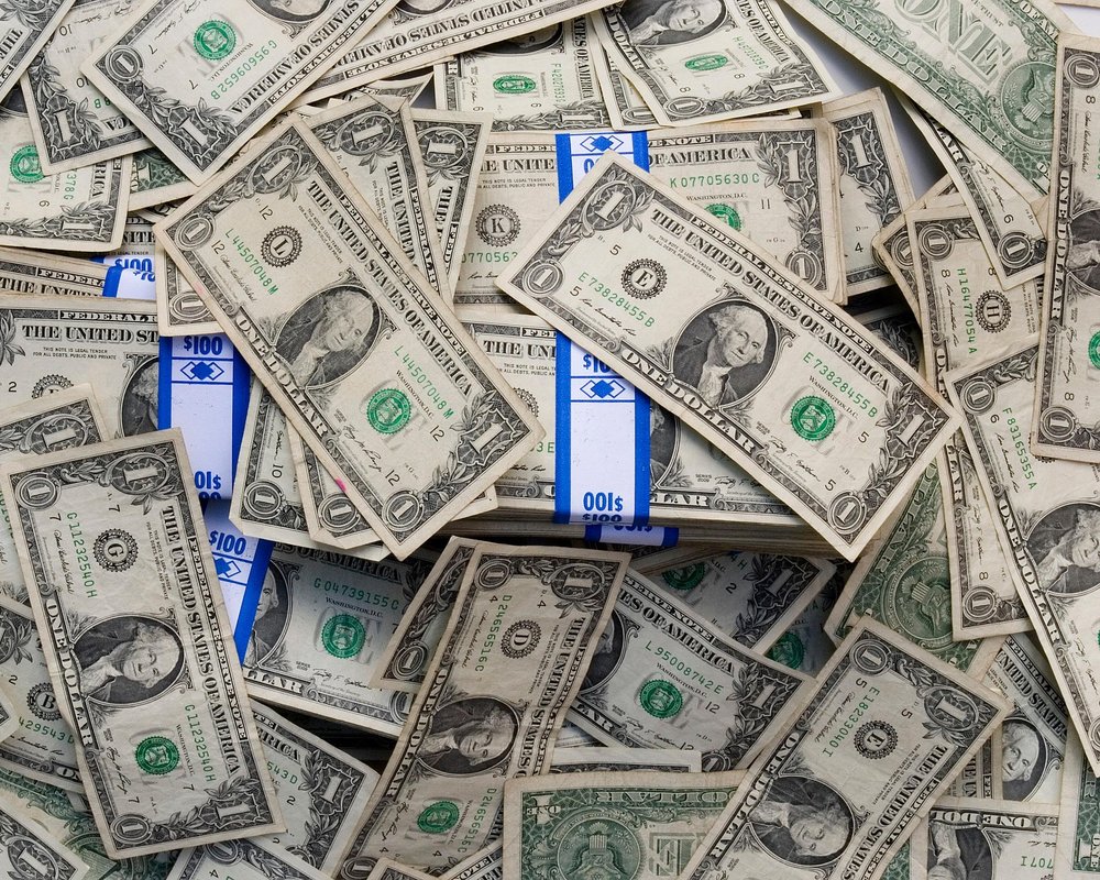 A messy pile of U.S. one-dollar bills